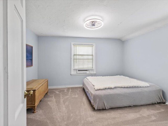 bedroom featuring carpet flooring and baseboards