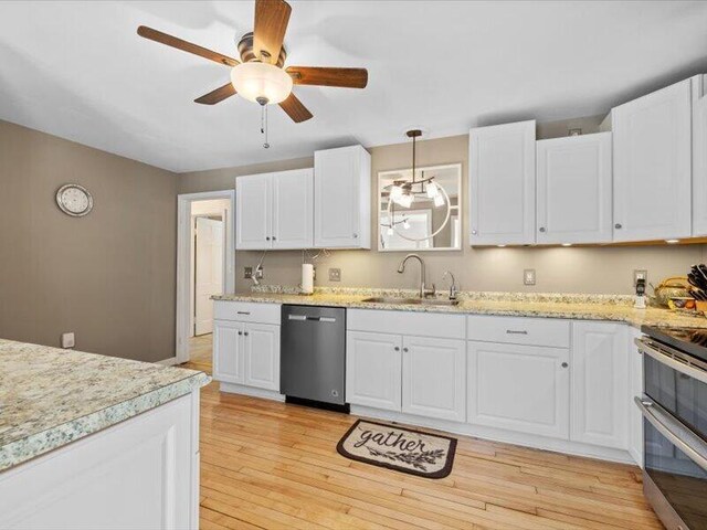 kitchen featuring white cabinets, stainless steel appliances, and ceiling fan