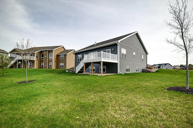 back of house featuring a wooden deck, stairs, and a yard