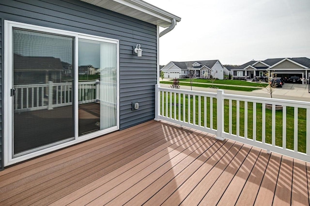 wooden deck featuring a yard and a residential view