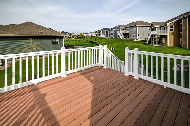 deck with a residential view, stairs, and a lawn
