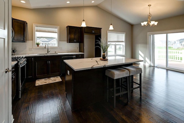 kitchen featuring a sink, vaulted ceiling, and a healthy amount of sunlight