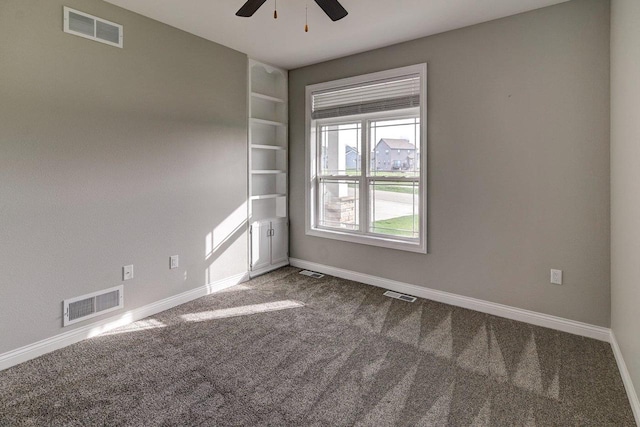 unfurnished room featuring carpet flooring, ceiling fan, and visible vents