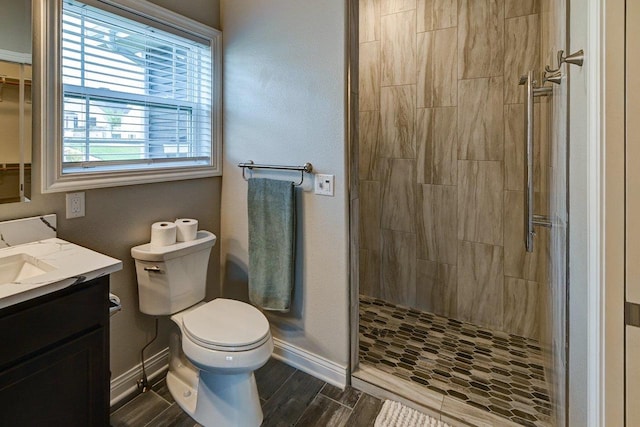 bathroom with baseboards and a tile shower
