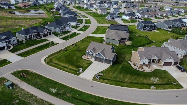 birds eye view of property with a residential view and a water view