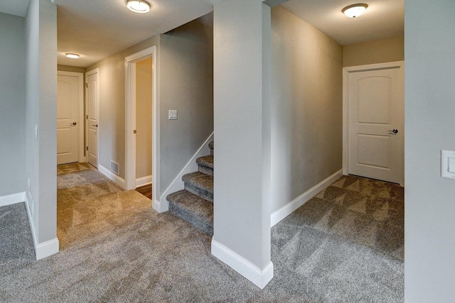 stairway featuring baseboards, carpet, and visible vents
