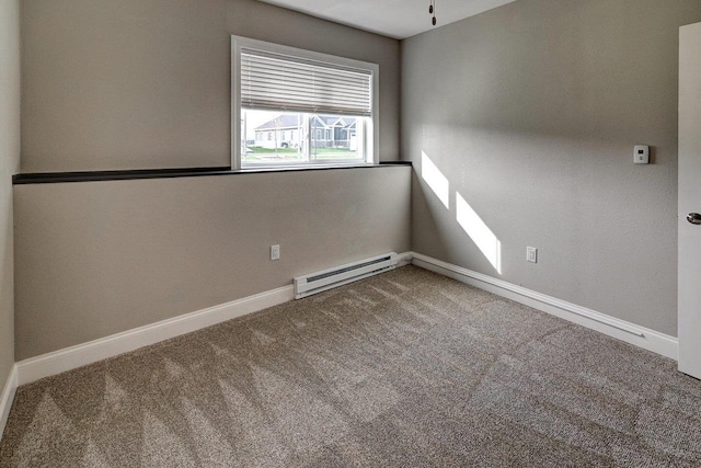 spare room featuring baseboards, a ceiling fan, carpet, and a baseboard heating unit