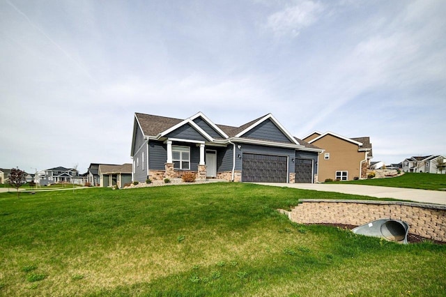 craftsman-style house featuring concrete driveway, a front yard, and a garage