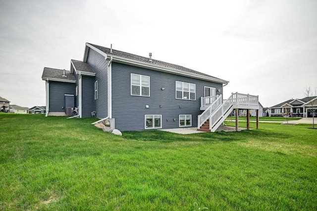 back of property with a lawn, a wooden deck, stairway, and cooling unit