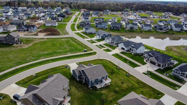 drone / aerial view featuring a residential view and a water view