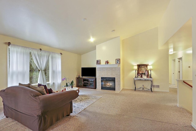956 Williams St, Walworth, WI 53184 - living area featuring visible vents, a fireplace, baseboards, carpet flooring, and vaulted ceiling