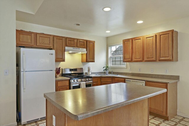 956 Williams St, Walworth, WI 53184 - kitchen with brown cabinets, a sink, under cabinet range hood, recessed lighting, and white appliances