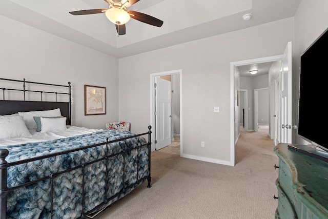 bedroom featuring baseboards, light carpet, and ceiling fan