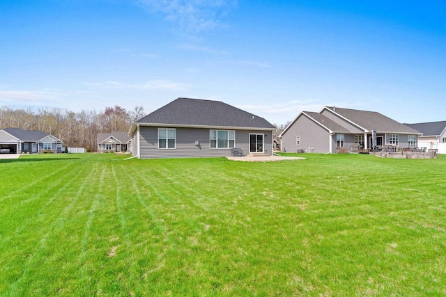 back of house featuring a yard and a patio area
