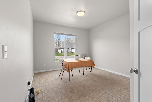 carpeted office featuring baseboards