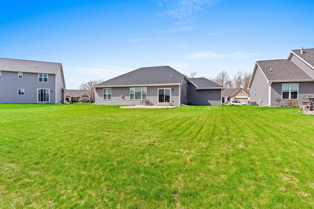 rear view of house with a yard and a patio
