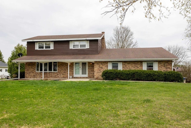 traditional-style home featuring brick siding and a front yard