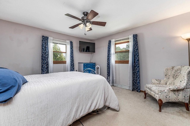 bedroom featuring baseboards, ceiling fan, and light carpet