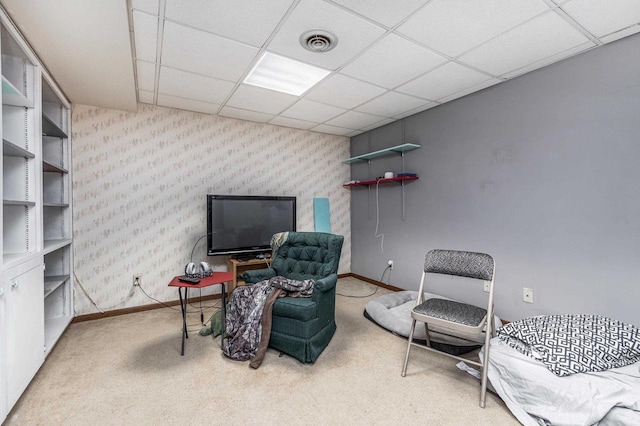 carpeted home office featuring baseboards, wallpapered walls, a paneled ceiling, and visible vents
