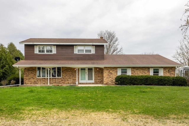 traditional-style home featuring brick siding, french doors, and a front lawn
