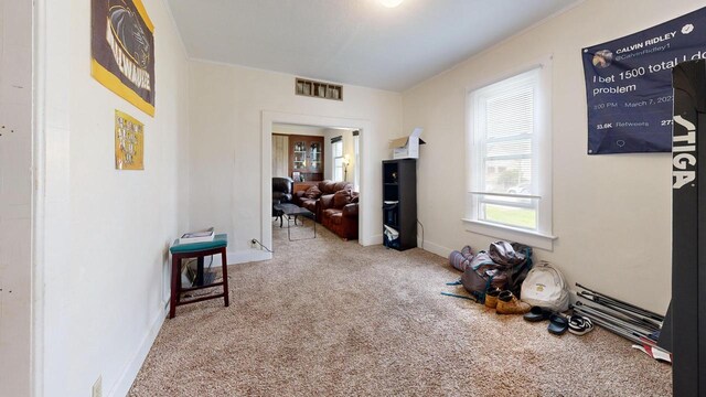 corridor featuring visible vents, baseboards, and carpet floors