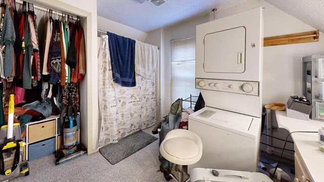 bathroom with visible vents, stacked washer and dryer, a textured ceiling, and curtained shower