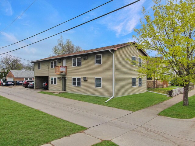 view of side of property featuring a yard and uncovered parking