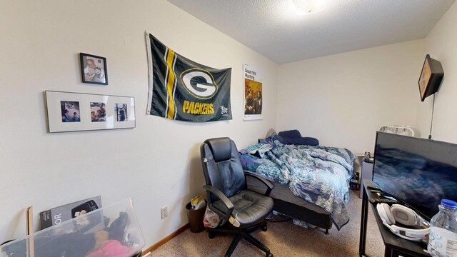 carpeted bedroom featuring baseboards and a textured ceiling
