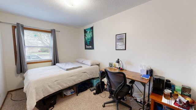 carpeted bedroom featuring a textured ceiling