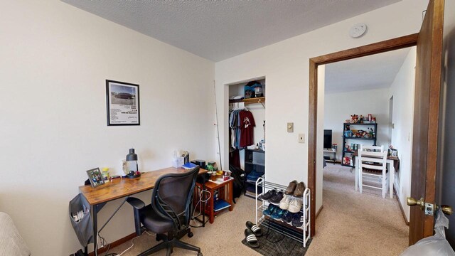 office area with a textured ceiling and carpet