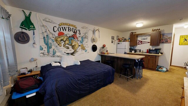 bedroom with freestanding refrigerator, a bar, and light carpet
