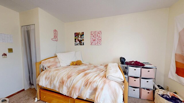 bedroom featuring carpet floors and baseboards