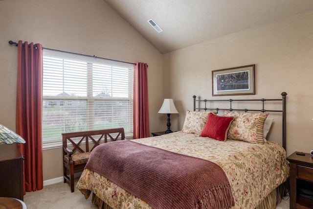 bedroom with light colored carpet, baseboards, visible vents, and vaulted ceiling