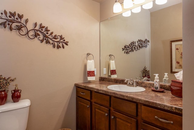 half bathroom with vanity and toilet
