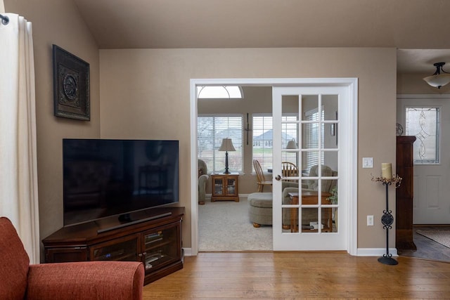 living area with baseboards and wood-type flooring