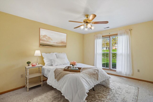 bedroom with visible vents, a ceiling fan, baseboards, and carpet floors