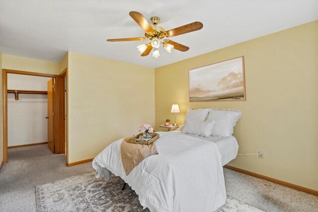 carpeted bedroom featuring a ceiling fan and baseboards