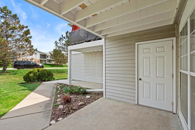 entrance to property featuring a lawn
