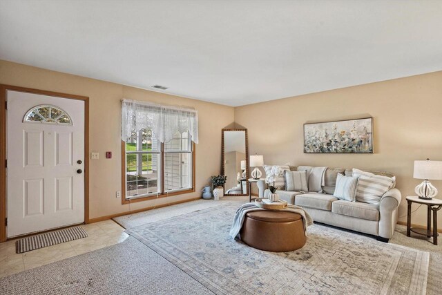 living room featuring baseboards and visible vents