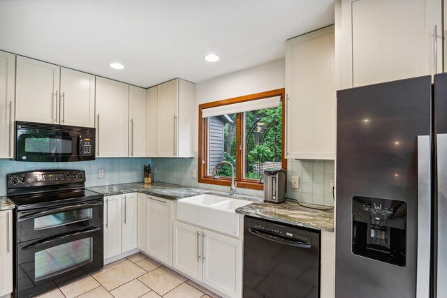 W10134 Schiefelbein Rd, Poynette, WI 53955 - kitchen with a sink, decorative backsplash, black appliances, and light stone countertops