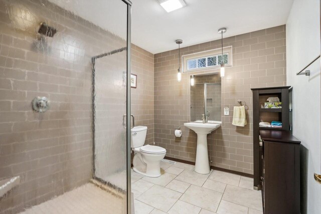 W10134 Schiefelbein Rd, Poynette, WI 53955 - full bath featuring toilet, tile walls, tile patterned floors, a shower stall, and a sink