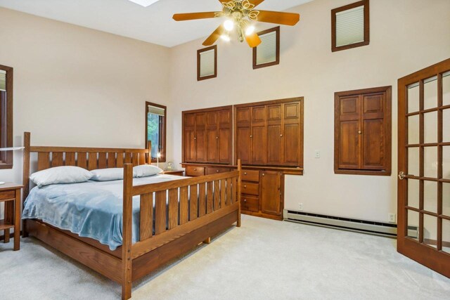 W10134 Schiefelbein Rd, Poynette, WI 53955 - bedroom featuring light colored carpet, a baseboard radiator, and a towering ceiling