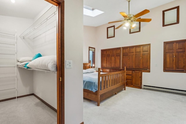 W10134 Schiefelbein Rd, Poynette, WI 53955 - bedroom with light colored carpet, a skylight, baseboards, a baseboard radiator, and a high ceiling