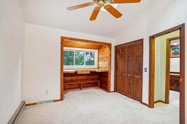 W10134 Schiefelbein Rd, Poynette, WI 53955 - unfurnished bedroom featuring visible vents, a closet, a baseboard heating unit, lofted ceiling, and light carpet