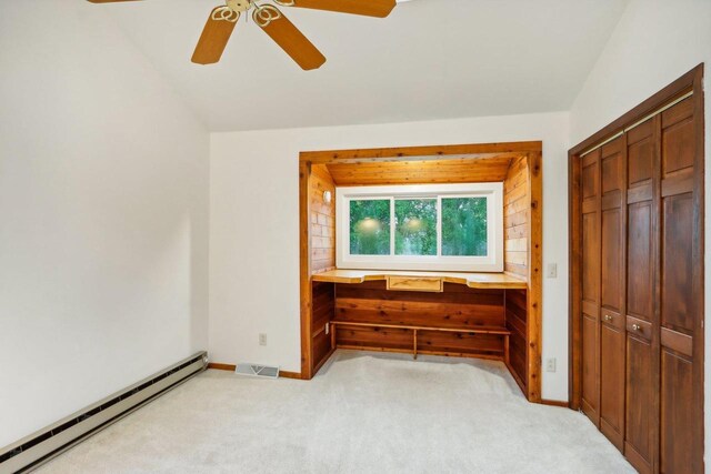 W10134 Schiefelbein Rd, Poynette, WI 53955 - unfurnished bedroom featuring visible vents, baseboards, a baseboard heating unit, and light colored carpet