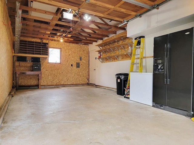 W10134 Schiefelbein Rd, Poynette, WI 53955 - garage with fridge, black refrigerator with ice dispenser, and a garage door opener