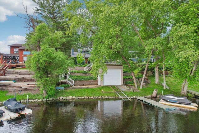 W10134 Schiefelbein Rd, Poynette, WI 53955 - exterior space with a garage, stairs, a water view, and a dock