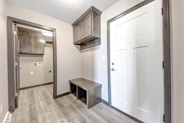 mudroom featuring baseboards and light wood-style flooring