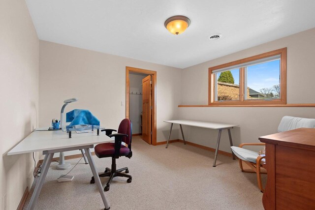 office with baseboards, light colored carpet, and visible vents