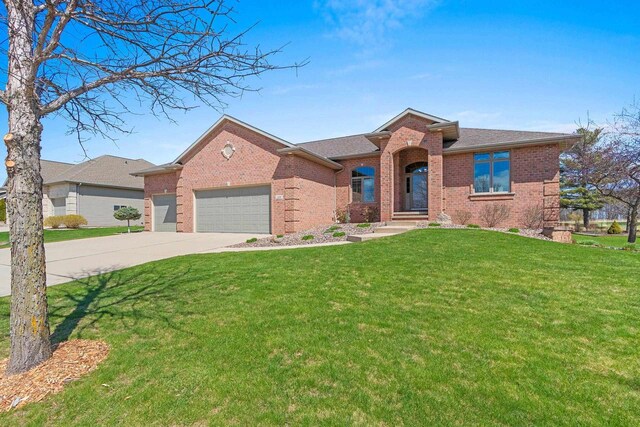 single story home with brick siding, driveway, a front lawn, and a garage